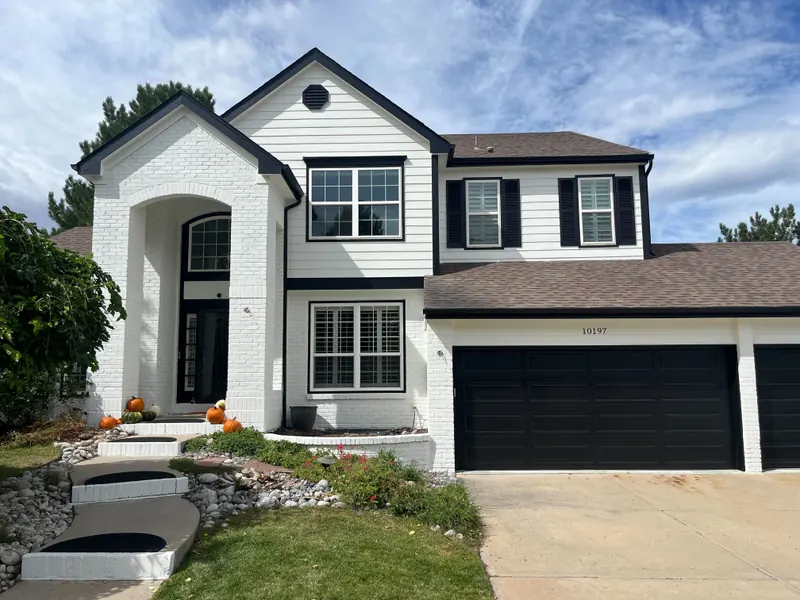 Repainted white two-story home with black trim and shutters in Highlands Ranch