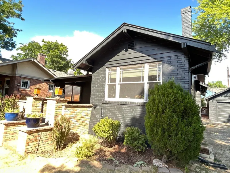 Repainted charcoal bungalow with brick accents in Highlands Ranch