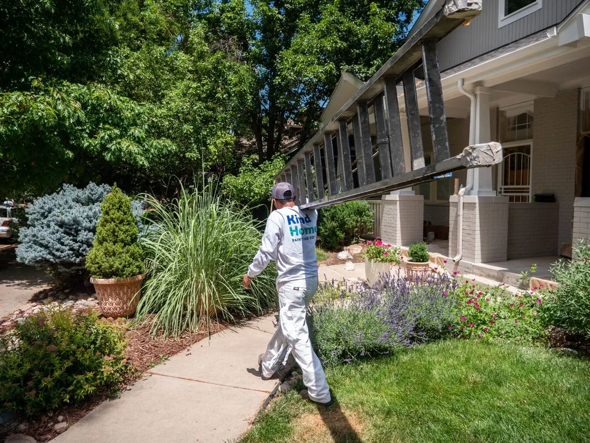 A Kind Home painter arriving with ladder at a Denver exterior project
